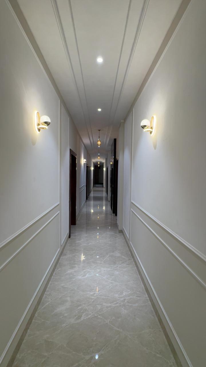 Hotel corridor with elegant lighting at THE ROYAL KING Ludhiana